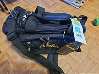 Overview of black Cabela's duffel bag with hangtag visible