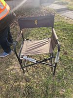 Front angled view showing seat, backrest with embroidered deer logo, and metal frame