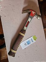 Full view of hammer showing head, handle, team logo and wear