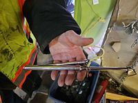 Full view of chrome tire pressure gauge in hand