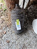 Full view of wire roll standing upright against post