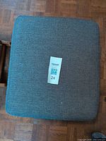 Top view of gray fabric upholstered ottoman