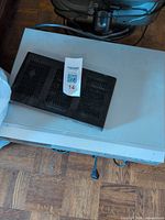 Top view of silver DVD player with black Motorola cable box stacked above