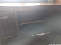 Front view showing two cabinet doors, open center shelf