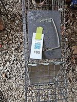 Top view of rectangular galvanized wire mesh trap with carrying handle and bait door visible
