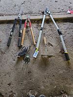 All six garden tools laid on floor