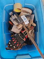 Top view blue bin containing gloves, bar clamp and tape