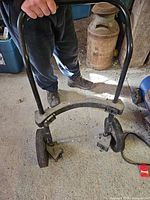 Full view of dolly with handle, wheels, and frame