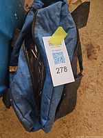 blue nylon tool bag partially unzipped showing contents
