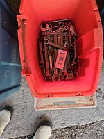 bin with numerous combination wrenches