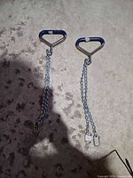 pair of chain ties laid out on floor showing full length and handles