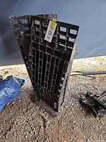 Two black plastic grid-style leveling ramps upright