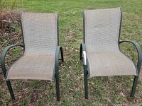 Front view of both patio chairs showing mesh seats, armrests, frame color and wear