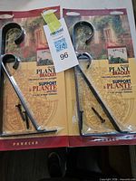 Two retail-packaged Panacea black steel hanging plant brackets with screws