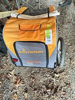 Rear view of Schwinn pet trailer showing fabric colors, logo, wheels, reflector, overall structure