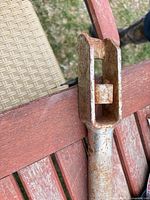 Boxed socket end of steel wrench handle showing rust and construction details