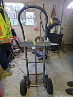 front view of steel hand truck showing frame, handle and wheels