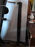 Full view of two-man crosscut saw showing blade length, tooth pattern and wooden handle