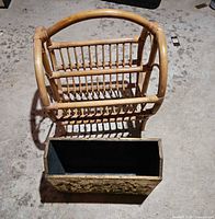 Rattan slat magazine rack alongside embossed gilt metal magazine holder, both visible in full