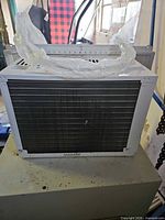 Front view showing condenser fins and brand badge