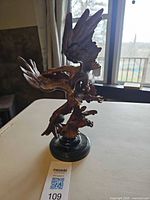 Full view of wood eagle sculpture on marble base