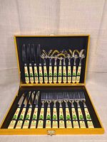 Open case showing all 24 utensils in molded interior