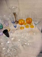 Assorted coloured and clear stemware grouped on tabletop