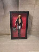 Front of unopened Barbie x MAC Cosmetics box showing doll and outfit