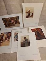 Six mounted art prints laid out showing subjects and condition