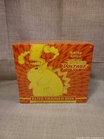 Front of sealed Pokémon Vivid Voltage Elite Trainer Box showing Pikachu design and age rating