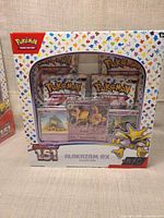 Front view of sealed Alakazam ex Collection box showing booster packs and promo cards