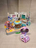 Overall view of amusement park base with ferris wheel, carousel and fold-out backdrop plus lavender compact