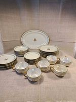Full set showing platter, stacked plates, bowls/saucers, teacups with luster interiors