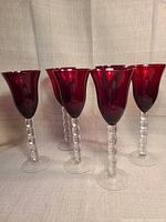 All six ruby red wine glasses front view