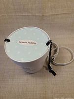 Overall view of handbag showing light blue printed top