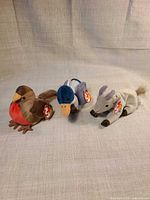 Front view of robin, mallard duck, and antelope plush toys with Ty tags visible