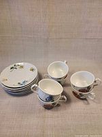 Stacked six saucers beside six teacups showing complete set