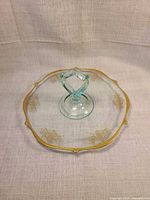 Top view showing gold rim, floral decals, aqua handle