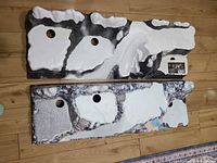 Both resin display bases lying flat showing snowy surfaces, circular cut-outs and fabric sections