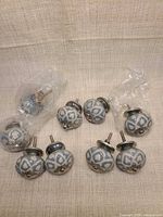 Full set of ten ceramic knobs with metal bases and screws