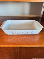 Full view of casserole dish showing starburst pattern and handles