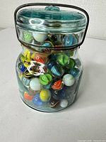 Full view of jar with lid, wire bail, and visible marbles