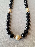 Full view of necklace strand showing bead pattern and accent beads