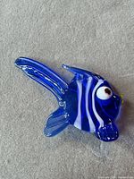 Blue blown glass fish figurine on fabric