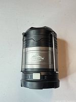 Front view of Cascade Mountain Tech collapsible LED lantern showing brand logo, metal handles and diffuser