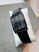 Front three-quarter view of the Citizen rectangular wristwatch on cushion