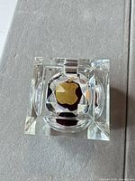 Top view of clear acrylic ring box showing gold accent and interior