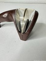 Side/front view of Cutco handheld knife sharpener showing clear guide plates