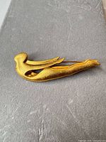 Full view of gold-tone abstract brooch