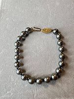 Full view of bracelet showing all faux pearl beads and clasp